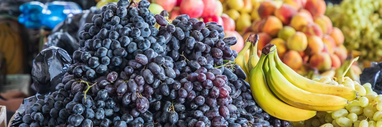 Closeup of various fruits including grapes and bananas